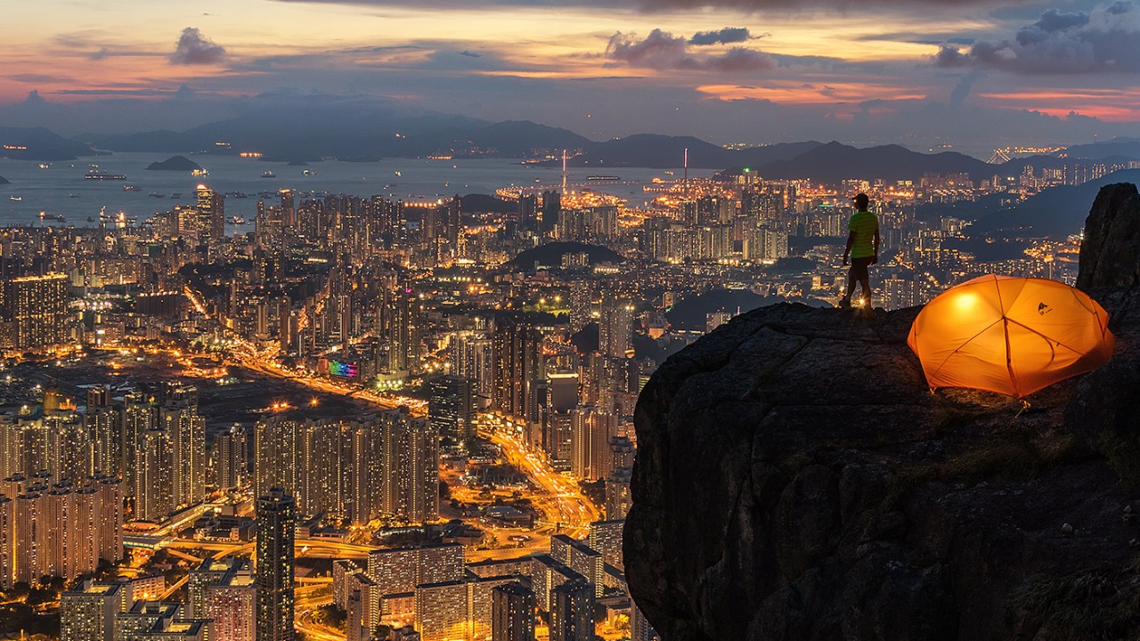 Man on hill at night overlooking the skyline; image used for HSBC Philippines Foreign currency savings accounts