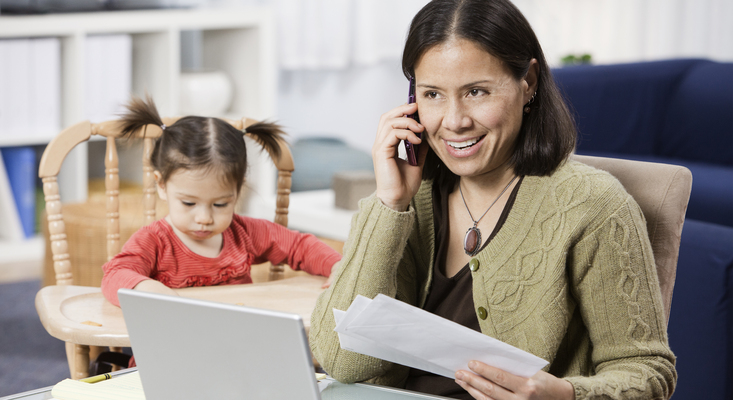 Mom talking on phone beside a child; image used for HSBC Philippines Online Banking FAQs