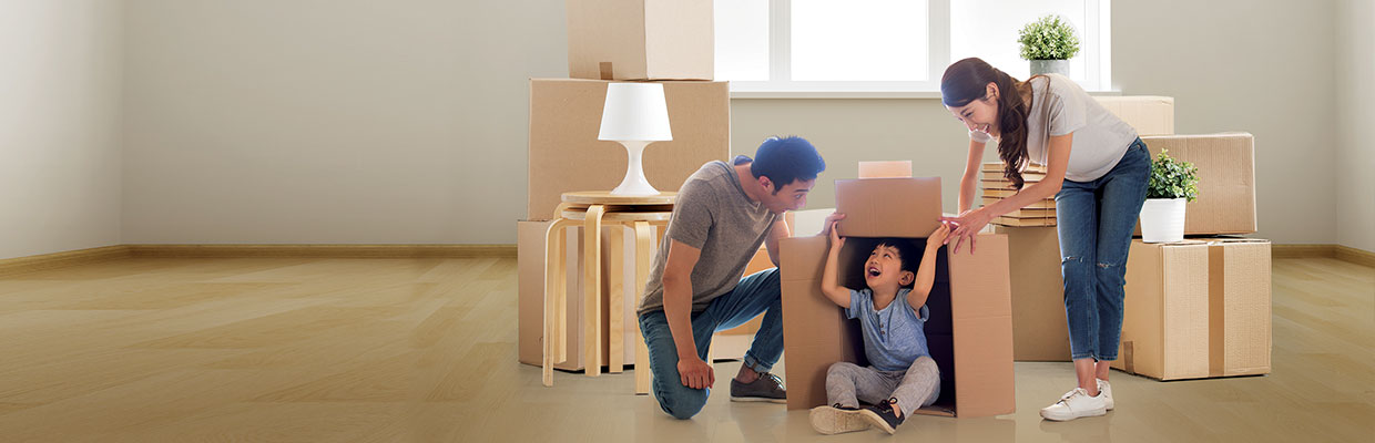 Family packing boxes and preparing to move house; image used for HSBC Philippines Personal Loan Application page