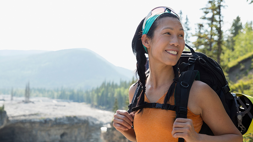 Female backpacker with an adventurous smile;  image used for HSBC Philippines Advance Individual Expertise and Support page