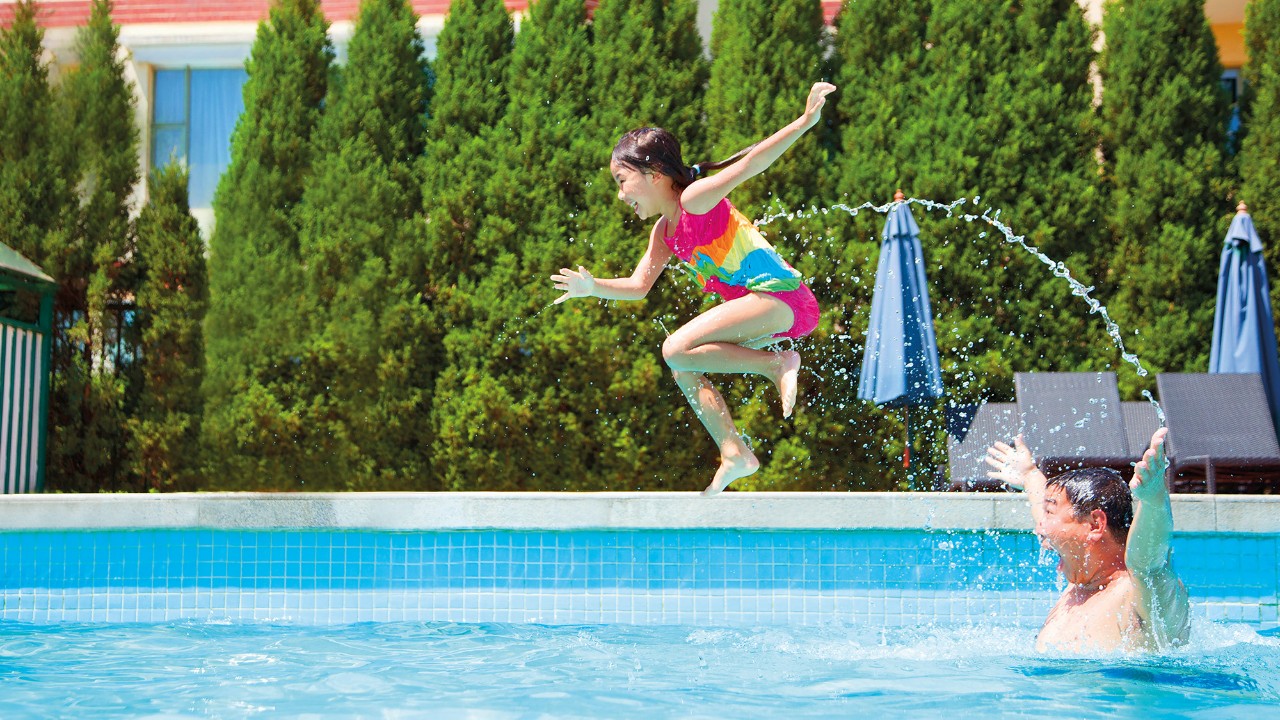 Child jumping into pool; image used for HSBC Philippines Advance Fast Access More Control page