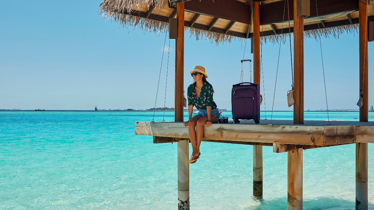 Lady sitting on the end of a dock; image used for HSBC Philippines Red Hot Deals Travel page