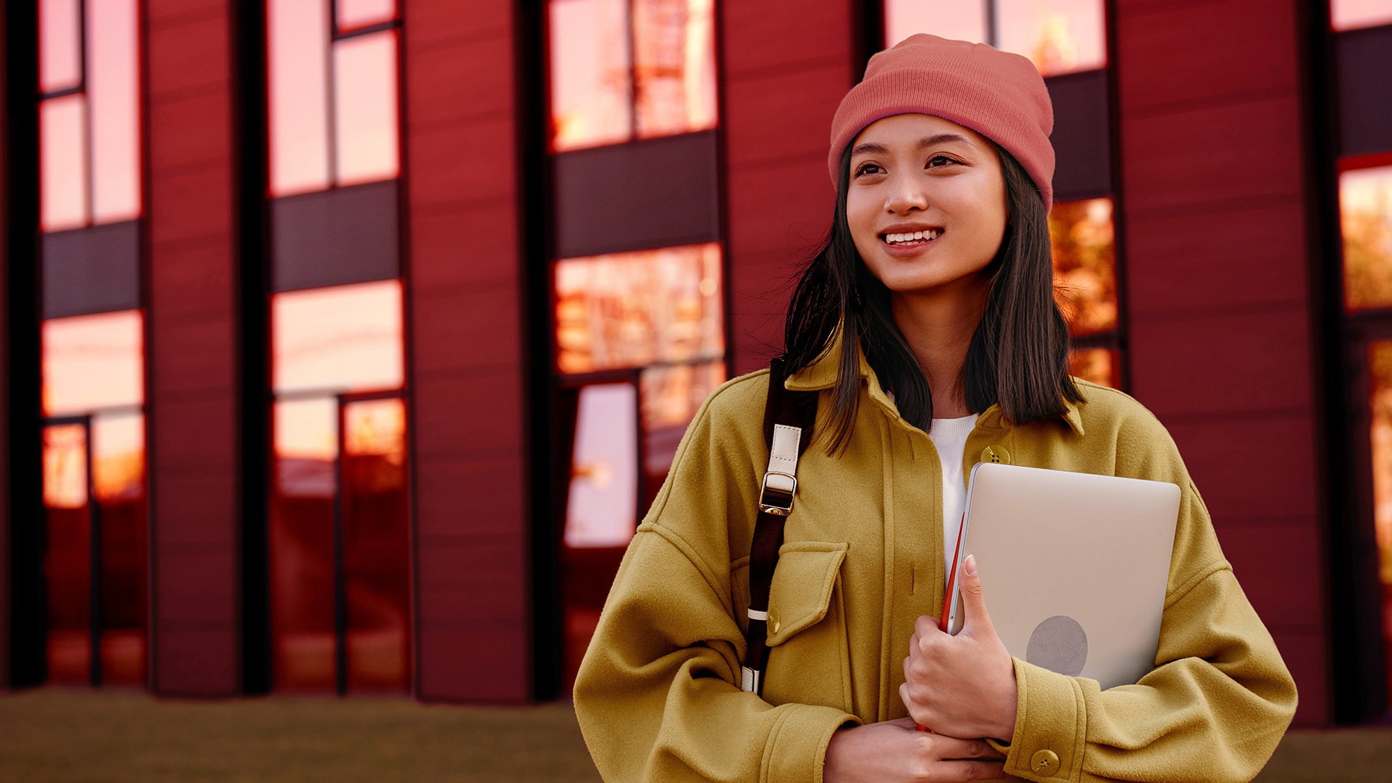Smiling woman holding the phone, preparing to study abroad, with her HSBC Premier accountke the first step in studying abroad