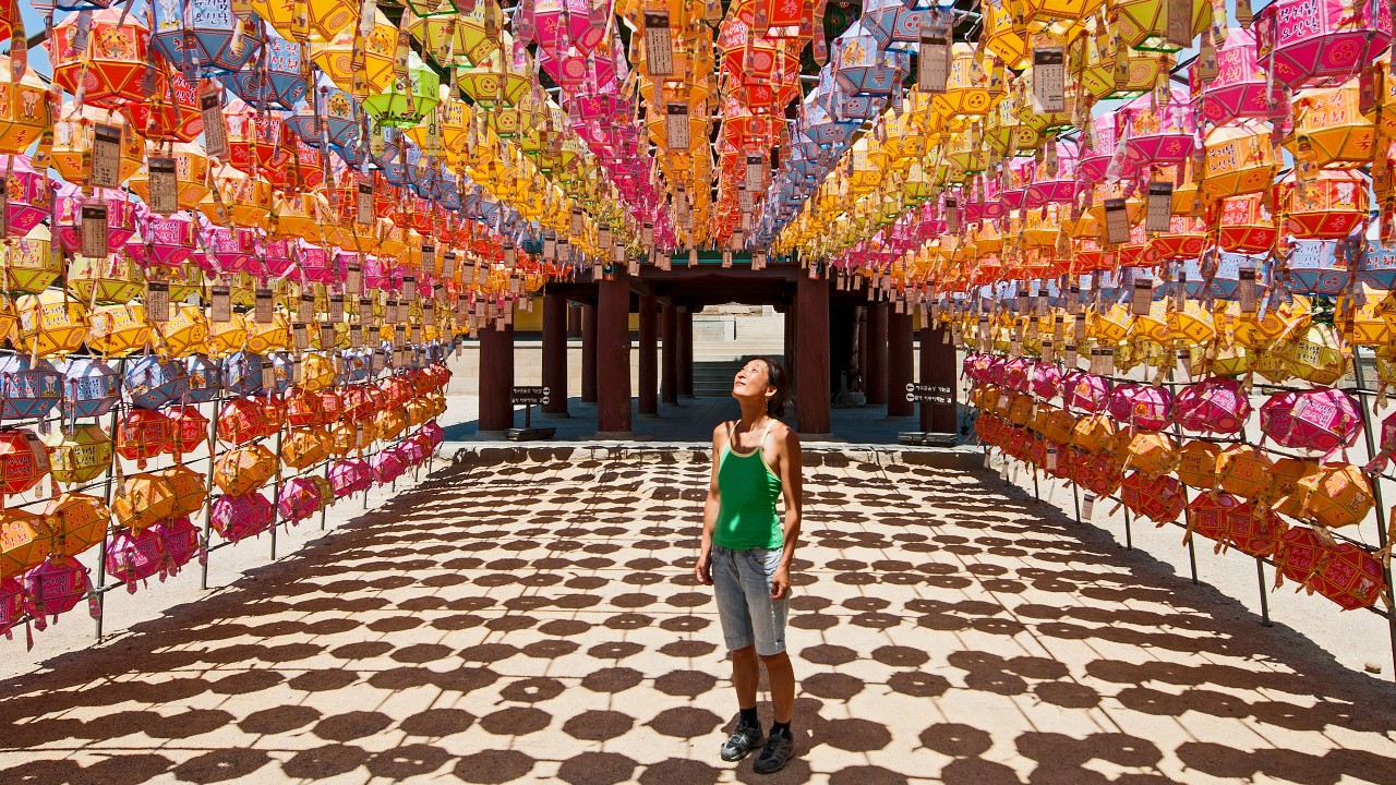 Asian woman looking at lantern at Korean temple; image used for HSBC Philippines Premier Offers Time Deposit Acquisition page