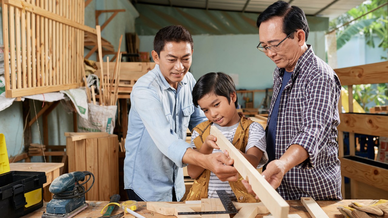 Boy learning woodworking; image used for HSBC Philippines Premier Wealth page