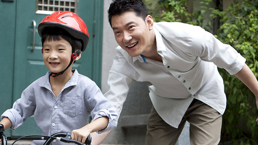 Father and son riding bicycle; image used for HSBC Philippines Insurance page