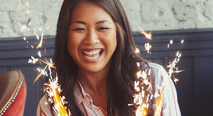 Woman with cake celebrating birthday; image used for HSBC Philippines Credit Card