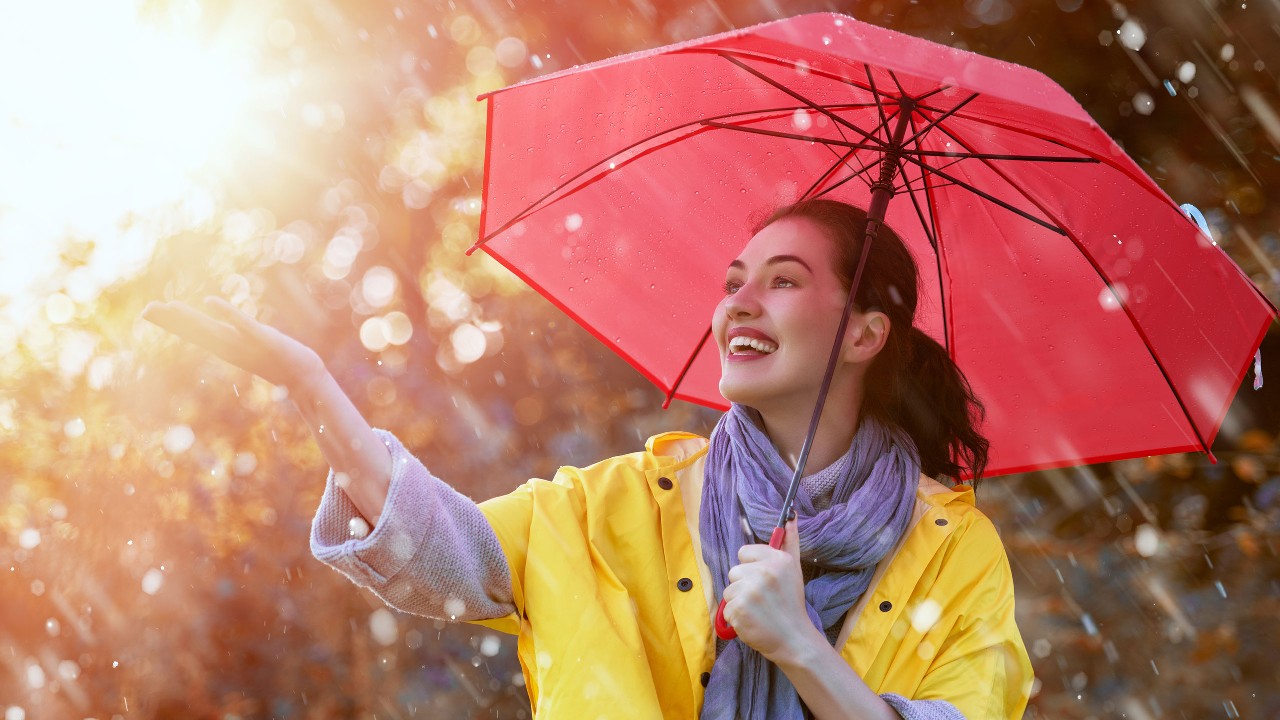 Woman holding umbrella in rain; image used for HSBC Philippines Credit Card Offers Free for Life Single Girl page