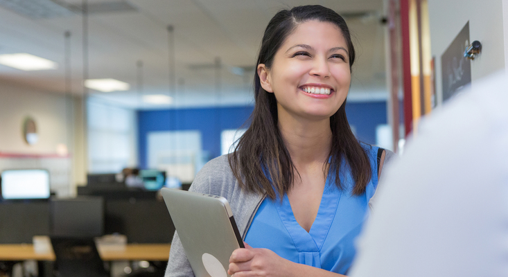 Woman smiling brightly at work; image used for HSBC Philippines Feedback and Complaints page