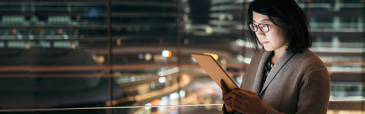 Woman is looking at her tablet in the office, image used for HSBC Philippines Help and Support