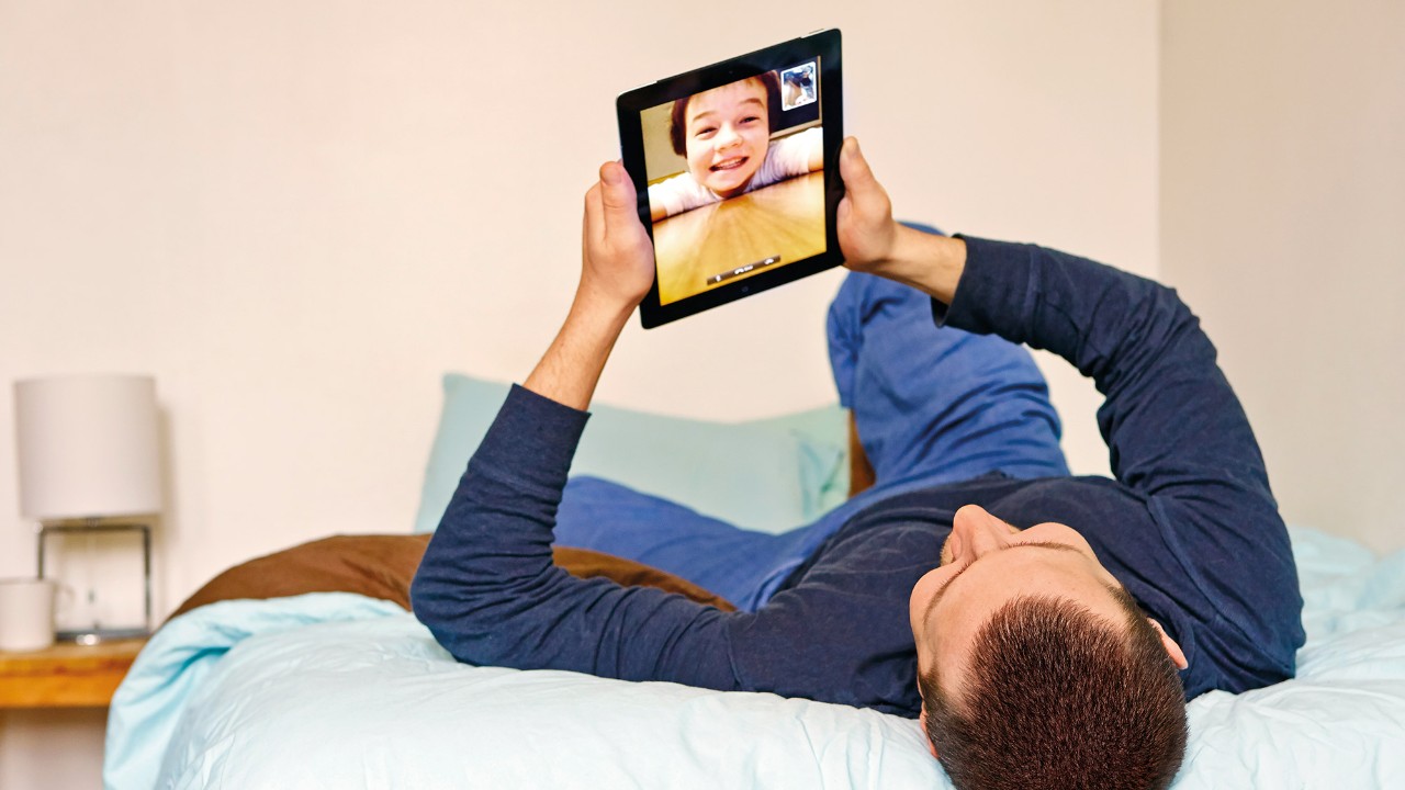 Father video calling child on ipad; image used for HSBC Philippines Advance Online and On Your Side page