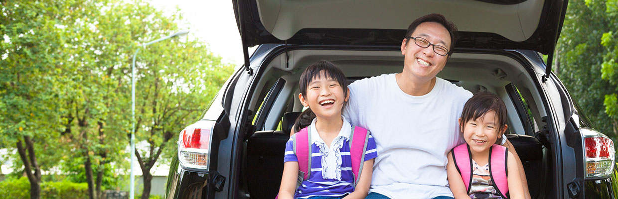 Father and daughters on a car; image used for HSBC Philippines Credit Cards Features Caltex Rebate page