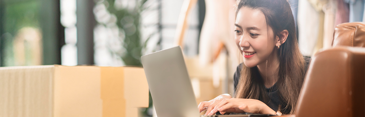 Woman using her laptop; Image for 'What is Online shopping?' article