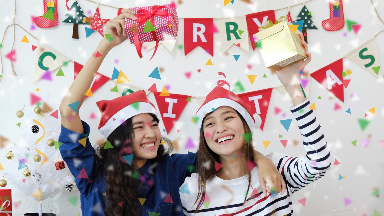 Two teenage girls celebrating Christmas at a party; image used for HSBC Philippines Credit Card Offers Free for Life Single Girl page