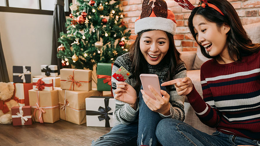 young girls paying their purchases by credit card