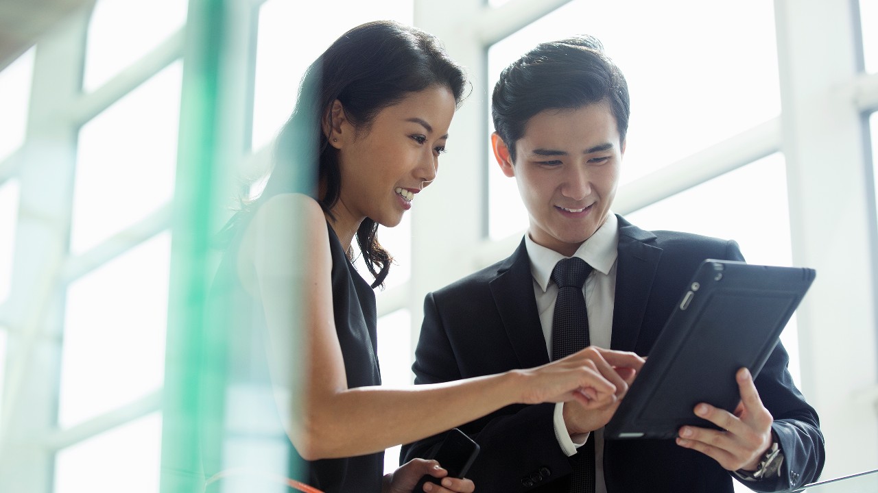 Man and woman using a table; Image for 'What is credit score?' article