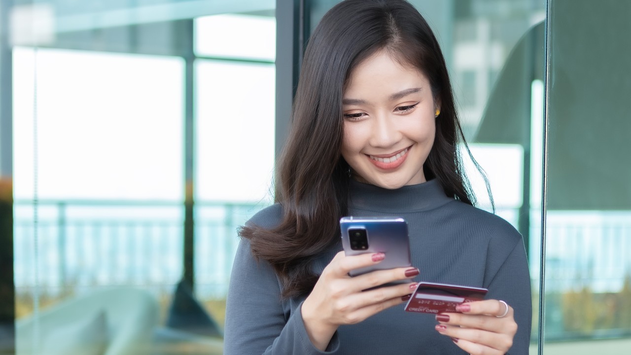 Woman using her phone; Image for 'What is credit limit?' article