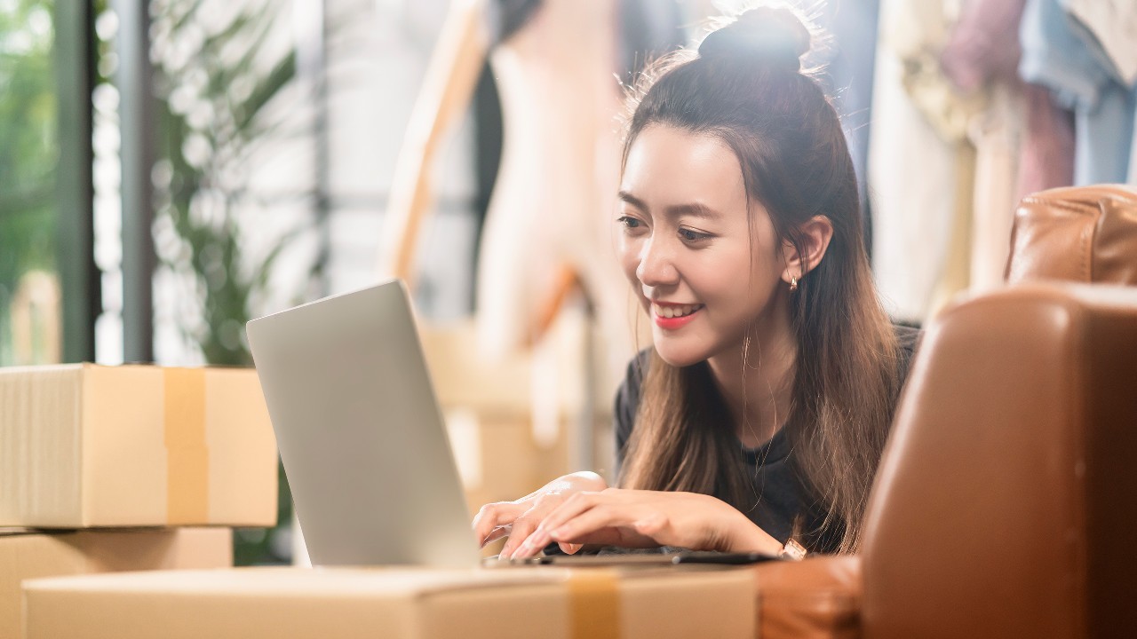 Woman using her laptop; Image for 'What is Online shopping?' article