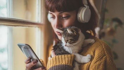woman and cat listening to Spotify