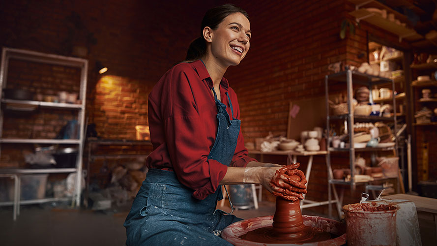 woman artist making pottery