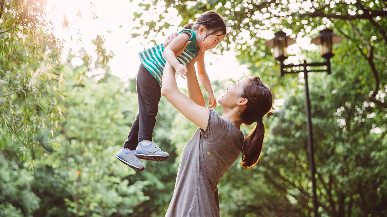 Mother throwing child in the air; image used for HSBC Philippines Mastercard Offers page