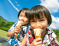 Two kids are eating ice creams in a sunny day, image used for HSBC Mastercard McDonald's Cashless Campaign.