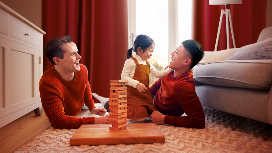 Same-sex couple playing with their child; Image used for HSBC Premier - Best Bank Account in the Philippines
