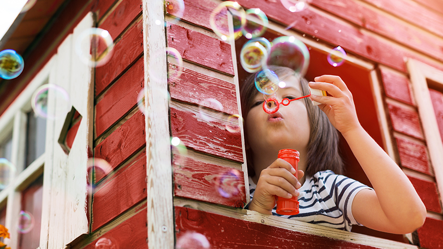 child blowing bubbles
