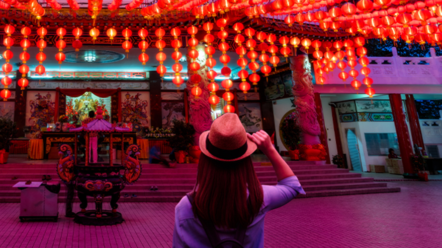 young woman traveler traveling and looking red lanterns; image used for HSBC Philippines Premier Account page