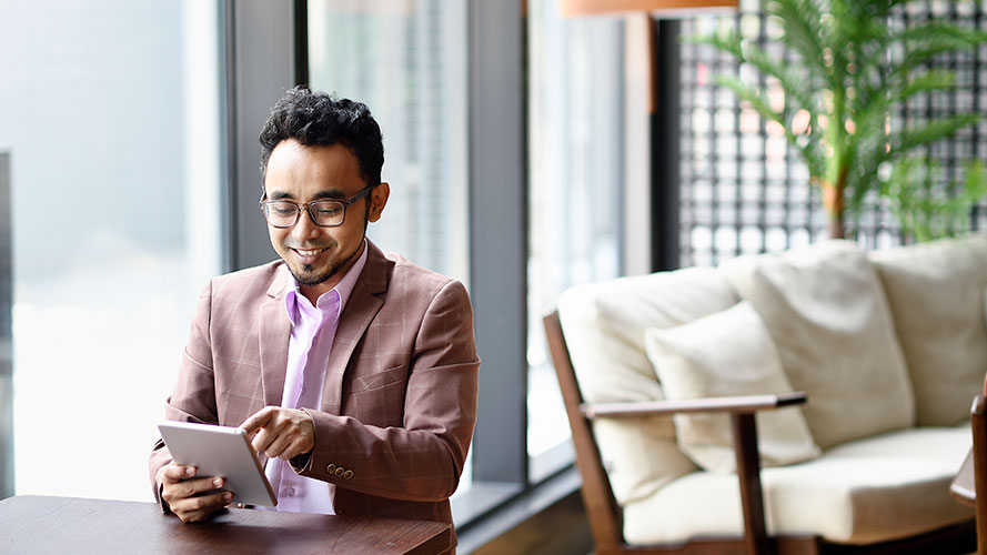 Business man working on his iPad; image used for HSBC Philippines