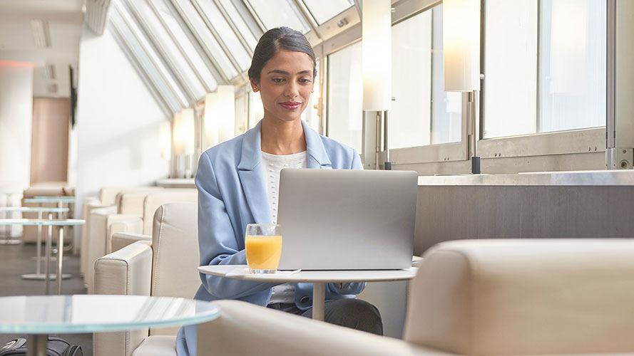 Lady at airport lounge on computer