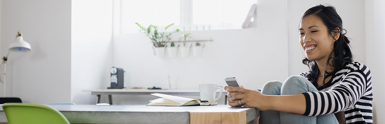 Woman is using her mobile phone, image used for HSBC Philippines Mobile Banking App